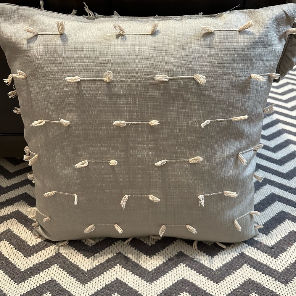 Elegant Gray Throw Pillow with Tassel Accents